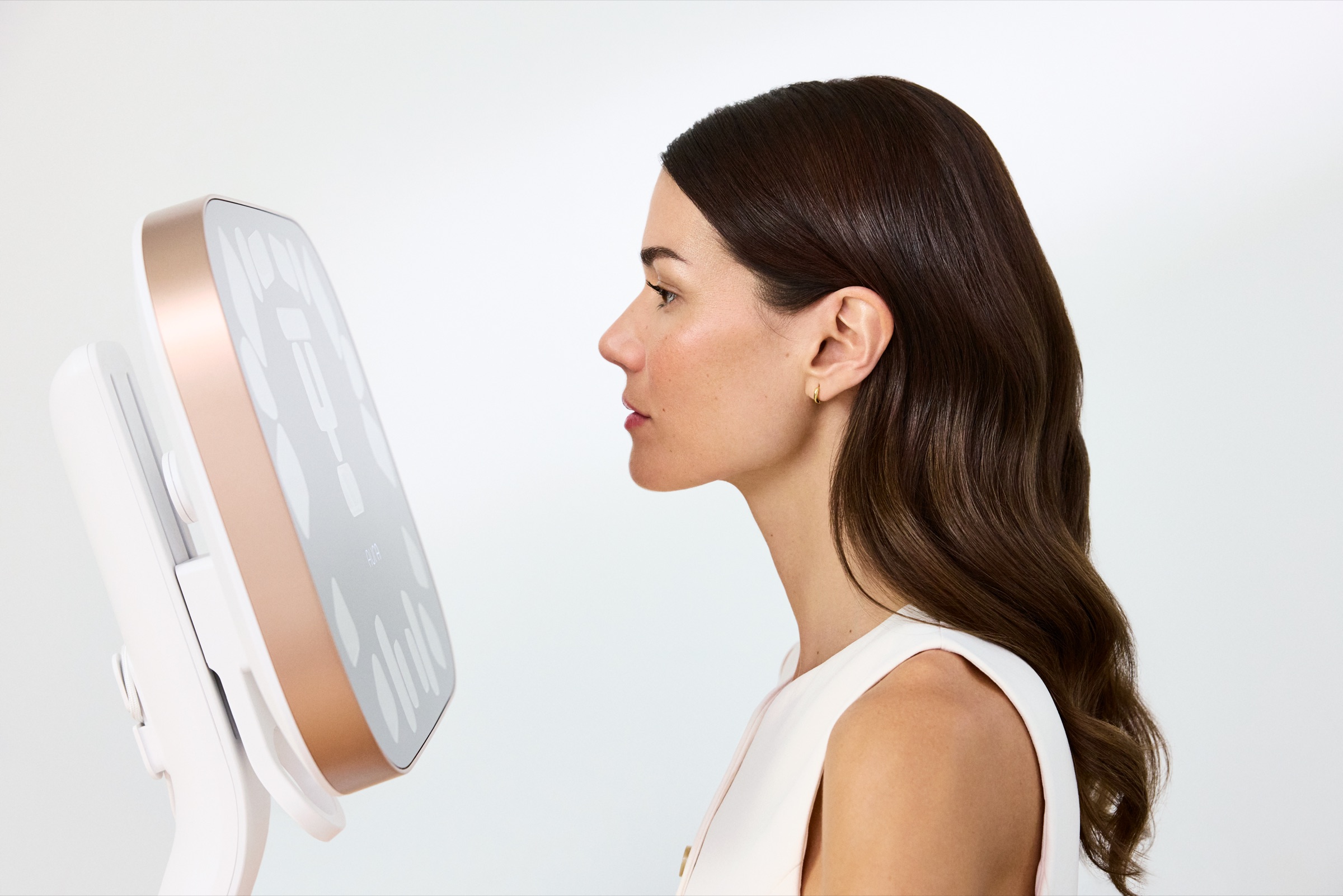 A patient in profile during an Aura 3D skin analysis session